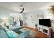 Cozy living room with comfortable blue furniture, TV, and access to dining area at 7 Clarendon Ct, Daytona Beach, FL 32118