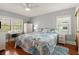 Bright bedroom with hardwood floors, ceiling fan, desk, and a decorative starfish-themed comforter at 7 Clarendon Ct, Daytona Beach, FL 32118