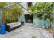 Inviting outdoor patio with comfortable seating, pergola, lush landscaping, and BBQ at 7 Clarendon Ct, Daytona Beach, FL 32118