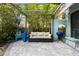 Inviting outdoor patio with comfortable seating, pergola, lush landscaping, and BBQ at 7 Clarendon Ct, Daytona Beach, FL 32118
