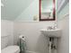 Charming powder room with beadboard paneling, pedestal sink, and coastal-themed decor at 7 Clarendon Ct, Daytona Beach, FL 32118