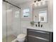 Modern bathroom featuring black fixtures, glass shower, marble countertop and ample lighting at 718 E Livingston St, Orlando, FL 32803