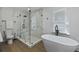 Modern bathroom with a glass-enclosed shower, soaking tub, and sleek fixtures at 718 E Livingston St, Orlando, FL 32803