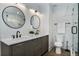 Elegant bathroom with double sinks, marble countertops, round mirrors, and a stylish walk-in shower at 718 E Livingston St, Orlando, FL 32803