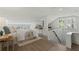 Bright bedroom with hardwood floors, neutral walls, and natural light from many windows, and a workspace at 718 E Livingston St, Orlando, FL 32803