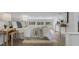Bright bedroom with hardwood floors, neutral walls, and natural light from many windows and lamps at 718 E Livingston St, Orlando, FL 32803
