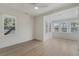 Bright bedroom features wood floors, neutral walls, a ceiling fan, and natural light from multiple windows at 718 E Livingston St, Orlando, FL 32803