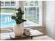 Close up of the breakfast nook table, decorated with a vase and mugs at 718 E Livingston St, Orlando, FL 32803
