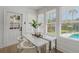 Bright breakfast nook with modern white chairs and view of the pool outside the windows at 718 E Livingston St, Orlando, FL 32803