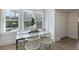 Bright breakfast nook featuring white chairs, stainless table and windows overlooking the pool at 718 E Livingston St, Orlando, FL 32803