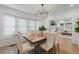 Bright dining room featuring stylish chandelier, wood floors, and open to living room at 718 E Livingston St, Orlando, FL 32803