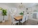 Bright dining room featuring stylish chandelier, wood floors, and open to kitchen at 718 E Livingston St, Orlando, FL 32803