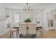 Bright dining room featuring stylish chandelier, bay window and wood floors at 718 E Livingston St, Orlando, FL 32803
