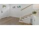 Bright foyer featuring light wood floors and staircase with white trim at 718 E Livingston St, Orlando, FL 32803