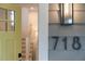 Inviting entrance with a bright yellow door and modern address numbers at 718 E Livingston St, Orlando, FL 32803