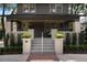 Inviting front porch with brick columns and planters and a bright doorway at 718 E Livingston St, Orlando, FL 32803
