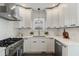 Modern kitchen with stainless steel appliances, white cabinetry and light countertops at 718 E Livingston St, Orlando, FL 32803