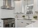 Modern kitchen with stainless steel appliances, white cabinetry and light countertops at 718 E Livingston St, Orlando, FL 32803