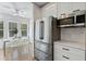 Modern kitchen with stainless steel appliances, white cabinetry and light countertops at 718 E Livingston St, Orlando, FL 32803