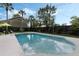 Inviting pool area with a spacious deck, lush landscaping, and comfortable seating, perfect for outdoor relaxation and entertaining at 718 E Livingston St, Orlando, FL 32803