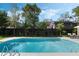 Backyard swimming pool and patio with lounge furniture and landscaped yard at 718 E Livingston St, Orlando, FL 32803