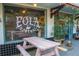Charming storefront with rustic wooden picnic table and inviting decor at 718 E Livingston St, Orlando, FL 32803