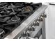 Close up of stainless steel stove with black grates and knobs at 718 E Livingston St, Orlando, FL 32803