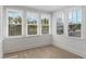 Sun-drenched sunroom with hardwood floors and multiple windows at 718 E Livingston St, Orlando, FL 32803