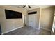 Bedroom with dark accent wall, ceiling fan, and double-door closet at 7525 Colbury Ave, Windermere, FL 34786