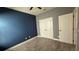 Bedroom with accent wall, ceiling fan and double-door closet at 7525 Colbury Ave, Windermere, FL 34786