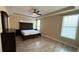 Bedroom with wood-look ceramic tile and tray ceiling at 7525 Colbury Ave, Windermere, FL 34786