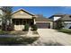 Charming home features a manicured lawn, a two-car garage, and a welcoming front porch at 7525 Colbury Ave, Windermere, FL 34786