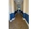 View of hallway featuring neutral wall paint, with a tiled floor and a beautiful archway at 7525 Colbury Ave, Windermere, FL 34786