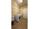 Functional laundry room with modern washer and dryer, plus storage and folding space at 7525 Colbury Ave, Windermere, FL 34786