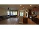 Open-concept living room with kitchen bar and natural lighting at 7525 Colbury Ave, Windermere, FL 34786