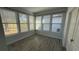 Sun room with wood-look ceramic tile flooring and many windows at 7525 Colbury Ave, Windermere, FL 34786