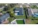 Aerial view of a home with a dark gray roof, screened in porch, and spacious green lawn at 825 Rosemere Cir, Orlando, FL 32835