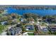 Aerial view of a home with a dark gray roof near a picturesque lake surrounded by lush greenery at 825 Rosemere Cir, Orlando, FL 32835