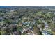 Wide aerial view of a home near a lake, surrounded by trees, and a well-manicured lawn at 825 Rosemere Cir, Orlando, FL 32835
