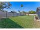 Large backyard showcasing a well-kept lawn, mature trees, and a privacy fence at 825 Rosemere Cir, Orlando, FL 32835