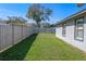 Well-maintained backyard featuring lush green grass and a privacy fence at 825 Rosemere Cir, Orlando, FL 32835