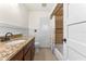 Bathroom with granite counters, tiled shower, and ample storage space at 825 Rosemere Cir, Orlando, FL 32835