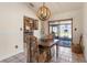 Cozy dining room featuring a chandelier and access to the outdoor patio at 825 Rosemere Cir, Orlando, FL 32835