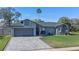 Charming home with a well-manicured lawn and paver driveway, showcasing curb appeal at 825 Rosemere Cir, Orlando, FL 32835