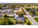 Aerial view of a single-Gathering home near a street and other residential buildings and a grassy area with mature trees at 864 Naples Dr, Orlando, FL 32804