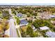 Aerial view of single Gathering home in residential neighborhood with mature trees and fenced backyard. Street view in foreground at 864 Naples Dr, Orlando, FL 32804
