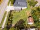 Aerial view of a backyard with a lush green lawn, wooden deck, privacy fence, and a storage shed at 864 Naples Dr, Orlando, FL 32804