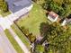 Aerial view of a backyard with a lush green lawn, wooden deck, privacy fence, and a storage shed at 864 Naples Dr, Orlando, FL 32804