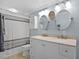 Bright bathroom with dual sinks, mirrors, and a shower at 864 Naples Dr, Orlando, FL 32804