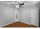 Bedroom featuring hardwood floors, a ceiling fan with lighting, a mirrored door closet, and white doors at 864 Naples Dr, Orlando, FL 32804